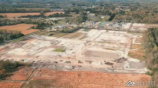 A large field with lots of dirt and trees.